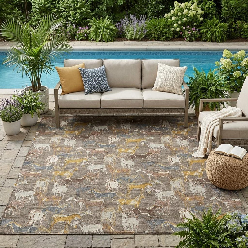 Outdoor area rug with taupe and gray horse motif and blue/yellow accents.