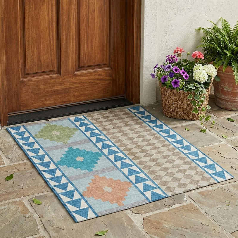 Teal and ivory southwestern area rug with geometric border pattern on an outdoor floor