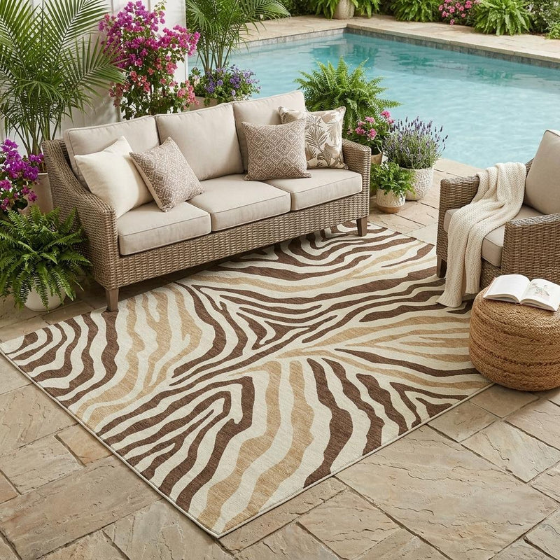 Zebra print indoor outdoor area rug in brown, beige, and cream with border