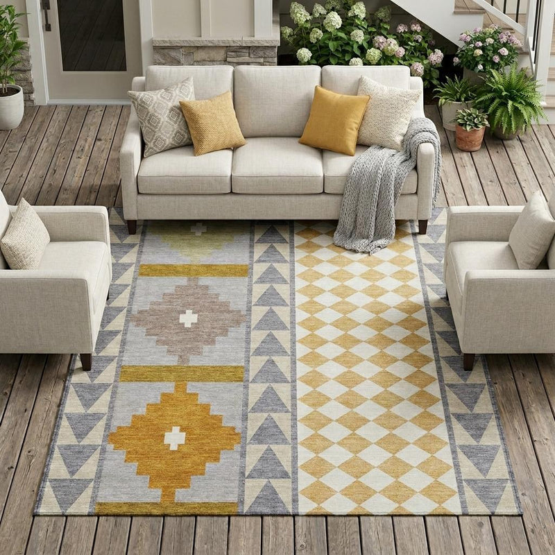 Gray, beige, and mustard geometric area rug laid in living room with couches