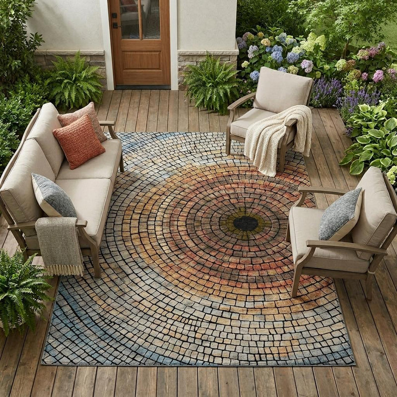 Outdoor indoor area rug with concentric geometric circles in cream, copper, orange, and blue