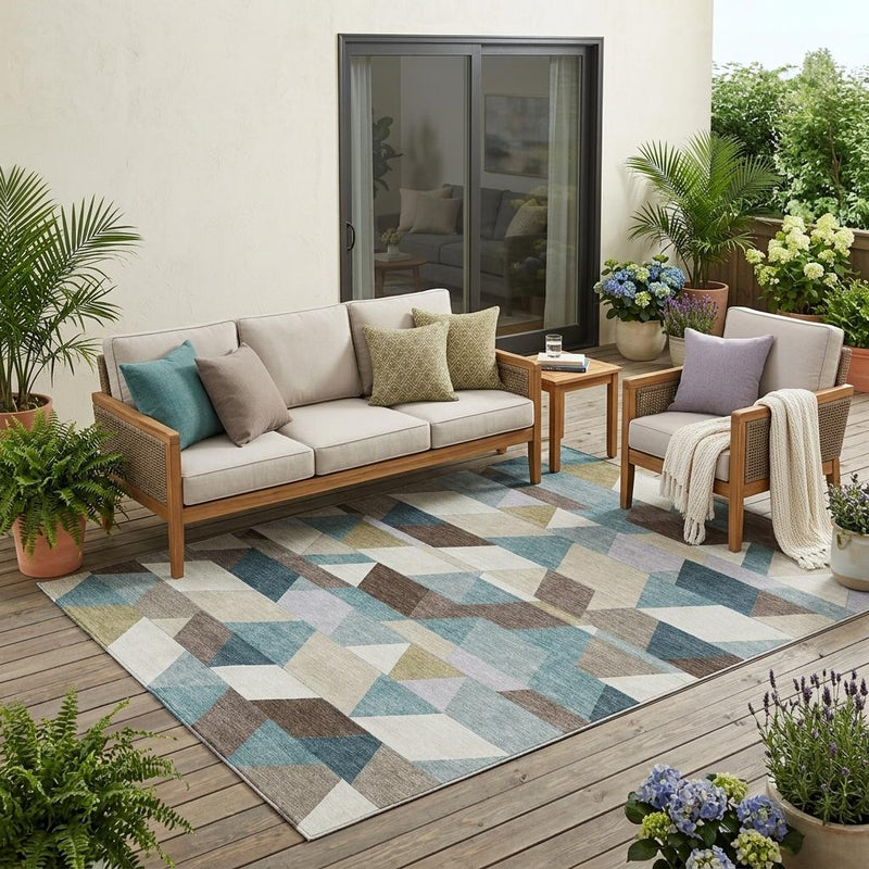 Indoor outdoor geometric area rug with teal, pale aqua, and cream triangle pattern