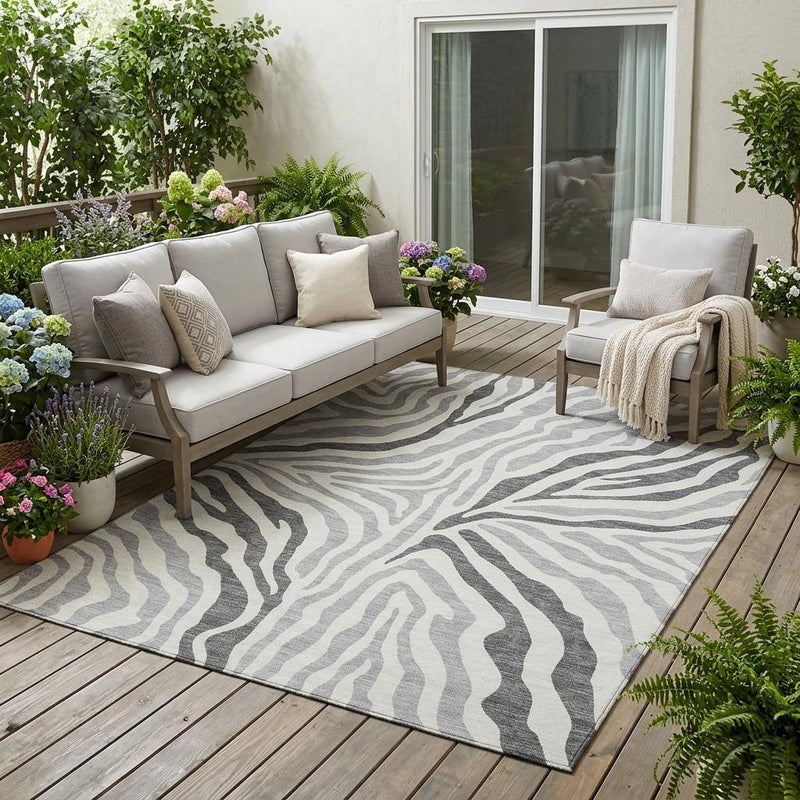 Gray and ivory zebra print area rug with large wavy stripe pattern.