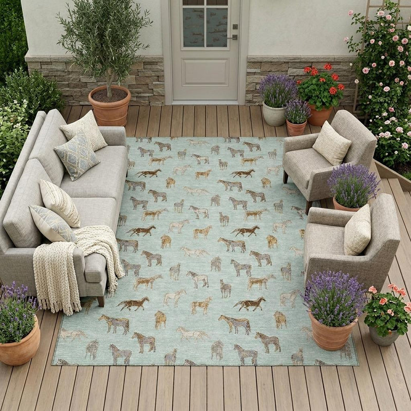 Mint green outdoor area rug with beige horse pattern on a patio seating set