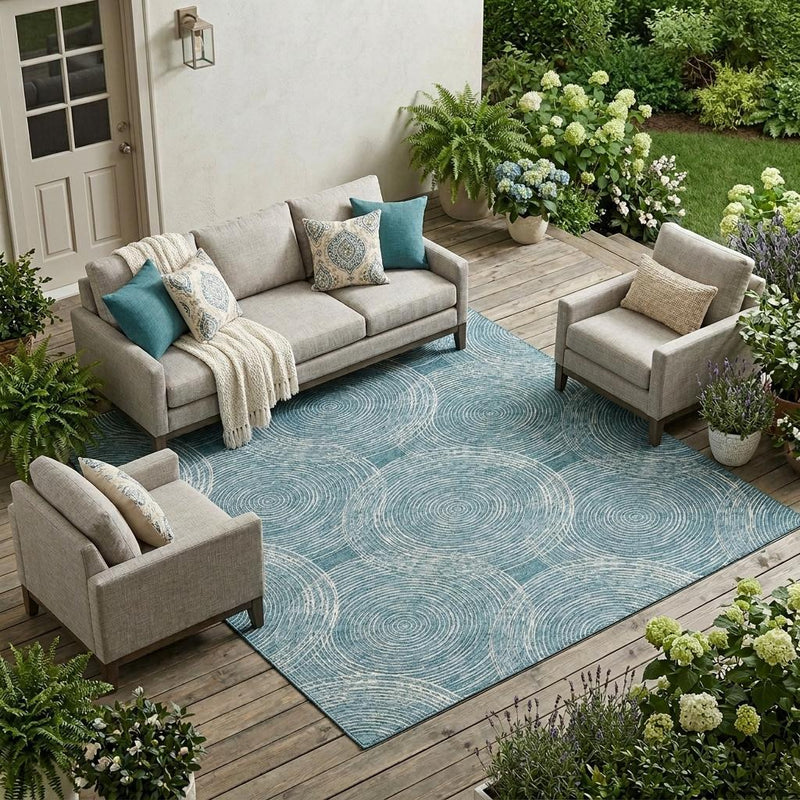 Teal blue geometric area rug with concentric circular line pattern in outdoor patio setting