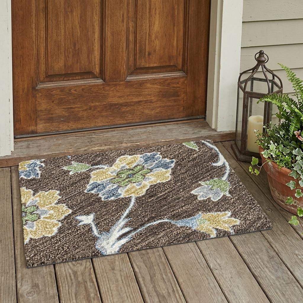 Brown floral outdoor rug featuring blue and yellow flowers, made from durable materials, perfect for entryways.