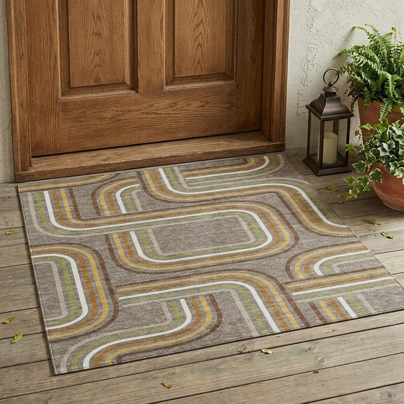 Geometric washable area rug on wood floor with taupe, ivory, and multicolor wavy stripe pattern