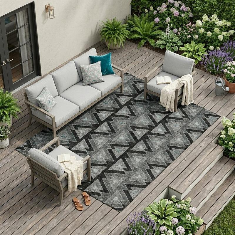 Outdoor patio area rug with black and gray geometric zigzag pattern.