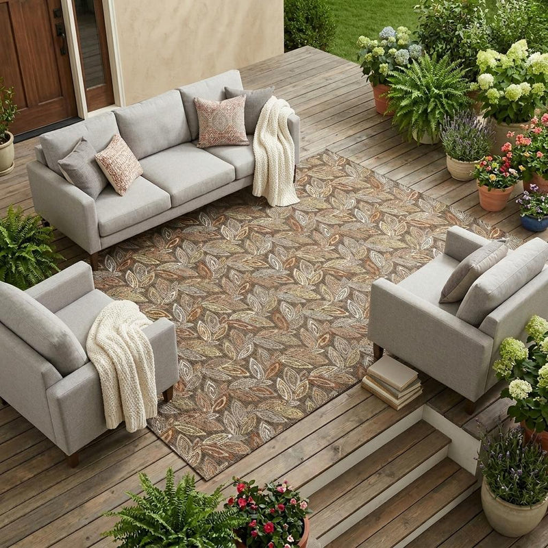 Outdoor patio scene featuring a leaf botanical area rug under seating and planters