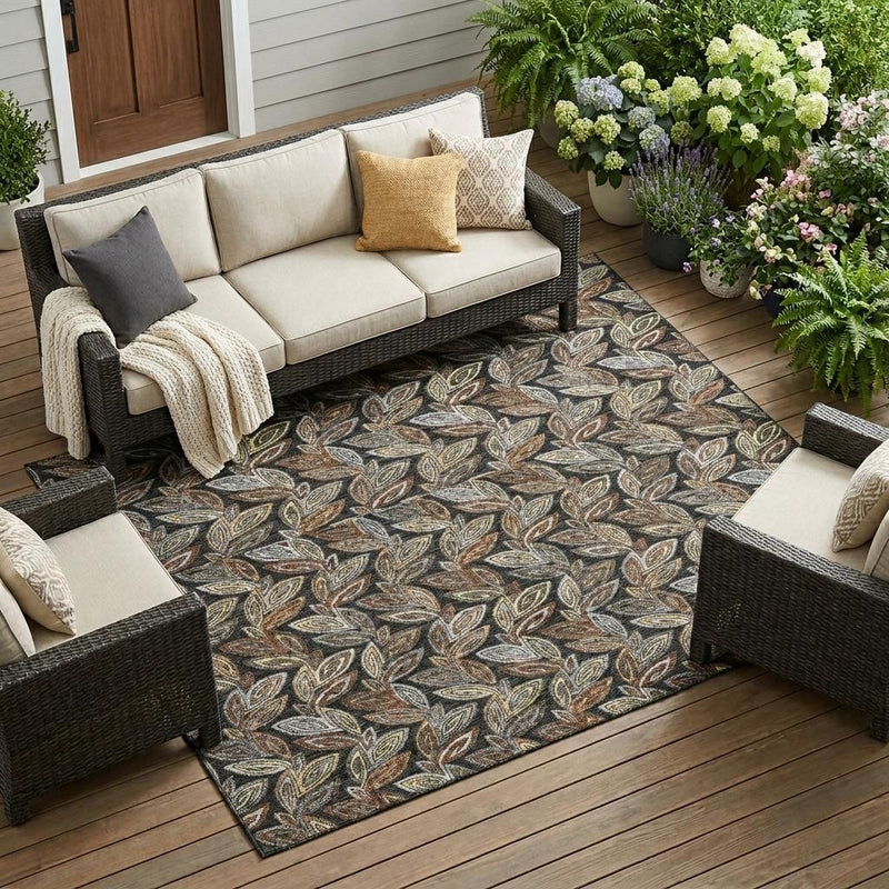 Outdoor indoor leaf-pattern area rug in charcoal gray with beige and tan accents