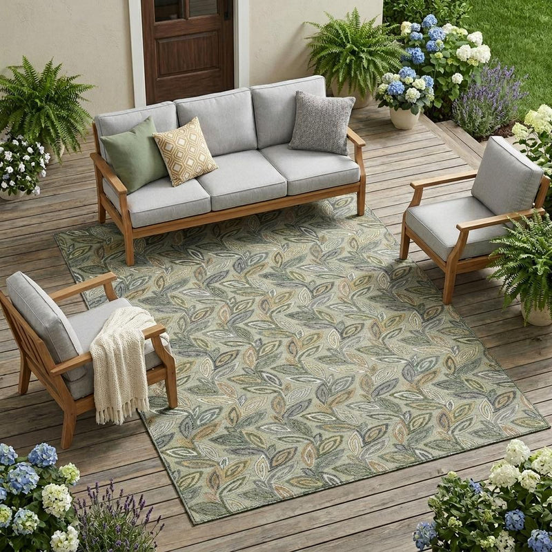 Outdoor patio area rug with botanical leaf pattern in gray, green, and ivory tones