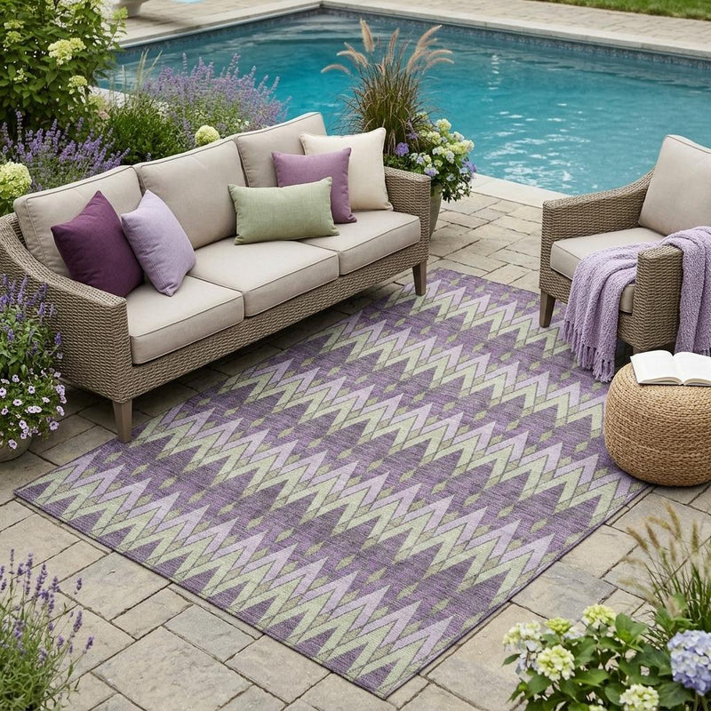 Purple geometric area rug with chevron pattern in teal, cream, and plum tones