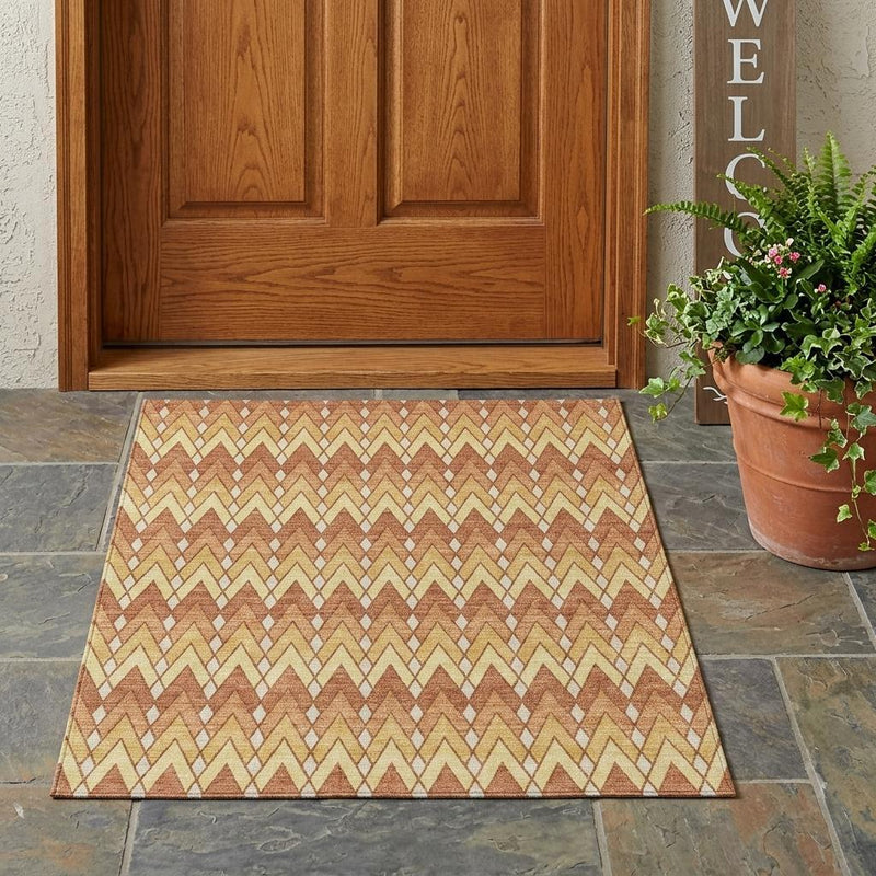Orange and copper geometric chevron area rug with cream zigzag design.