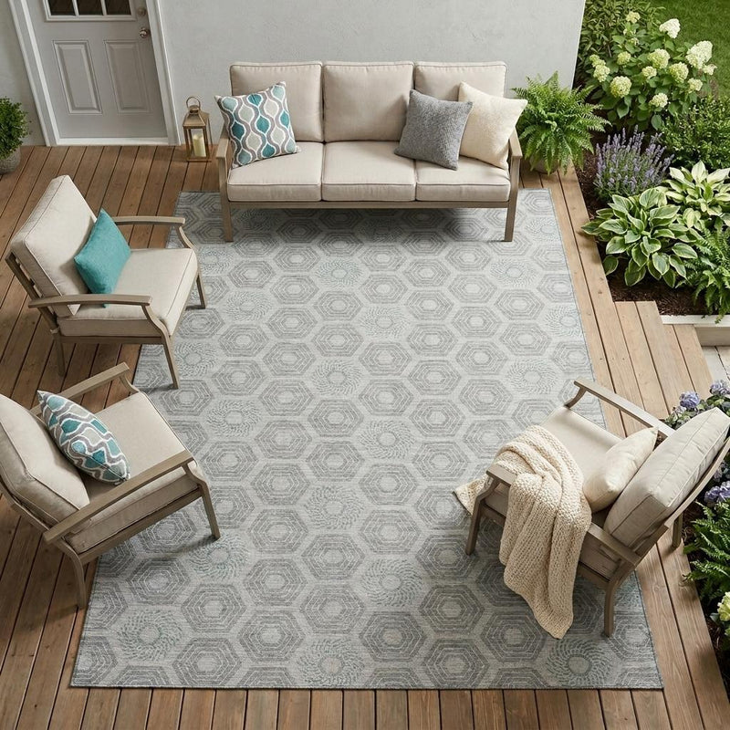 Rectangular outdoor area rug with silver and granite gray hexagon geometric pattern