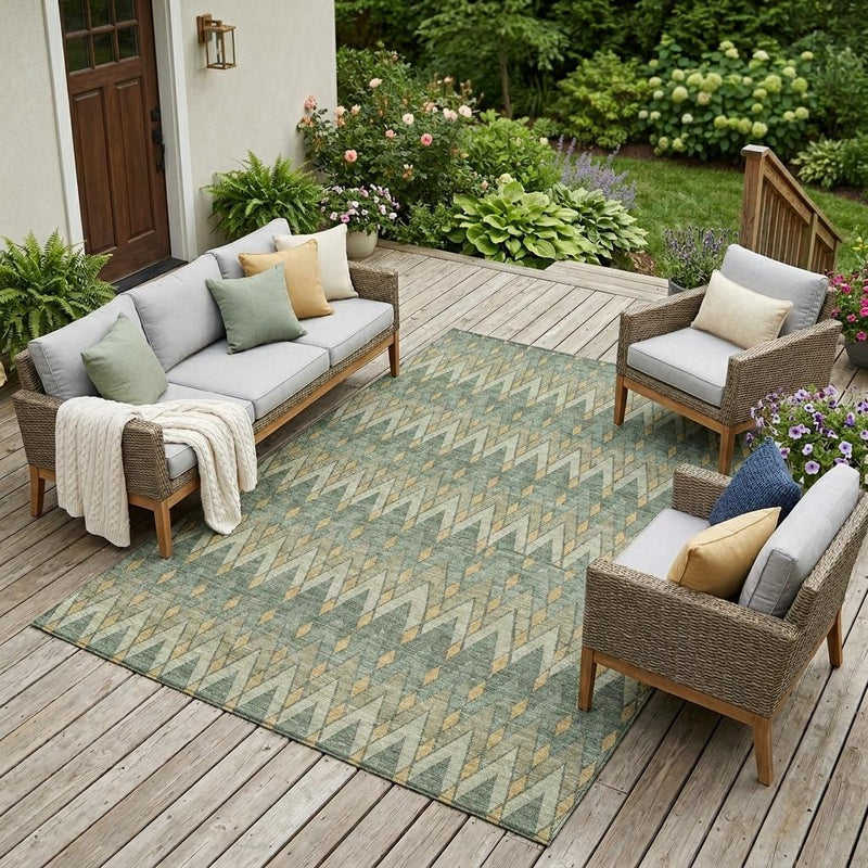 Green and gold geometric area rug on an outdoor patio deck with matching seating.