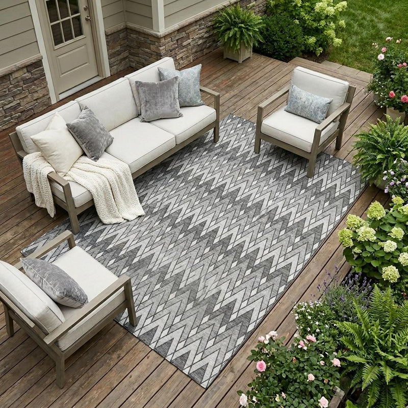 Indoor/outdoor patio seating set with charcoal and black chevron geometric area rug