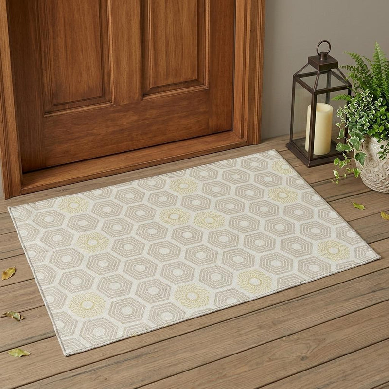 Geometric area rug in ivory and beige with hexagon pattern on wooden floor