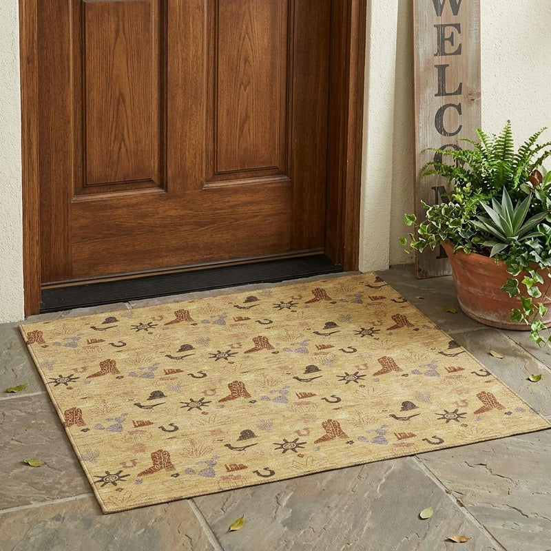 Rectangular gold area rug with multicolor desert icon pattern on floor.