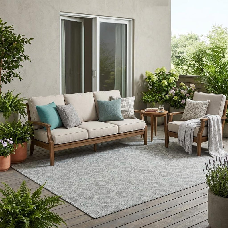 Silver-gray geometric hexagon area rug laid outdoors on wooden deck