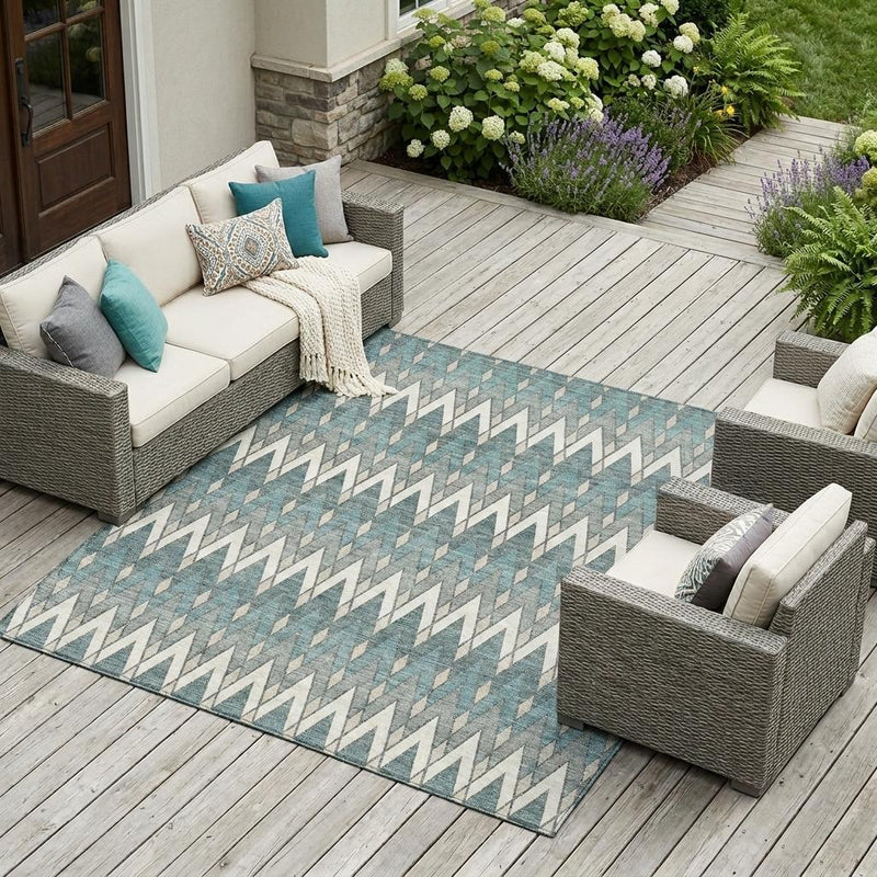 Teal blue geometric chevron area rug on outdoor patio with seating