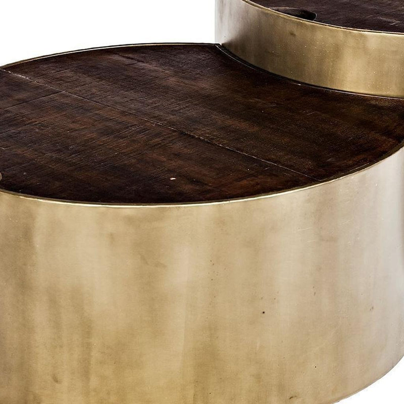 Close-up of dark wood round tabletop with gold metal base for nesting table