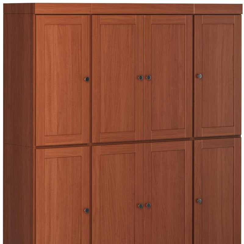 Brown wood pantry cabinet close-up of paneled door fronts with metal knobs