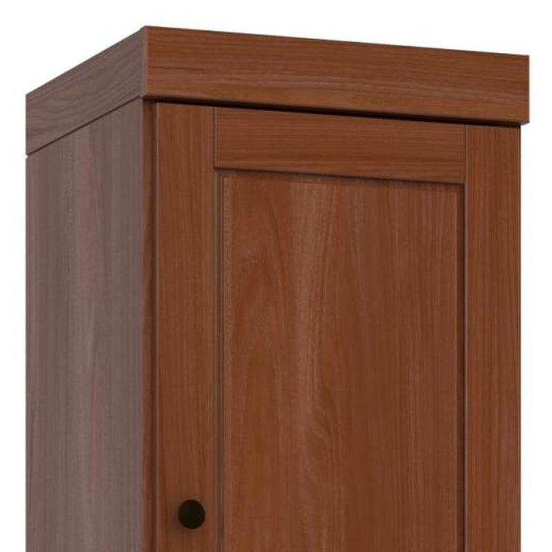 Solid wood pantry cabinet door with raised panel and round black knob pull
