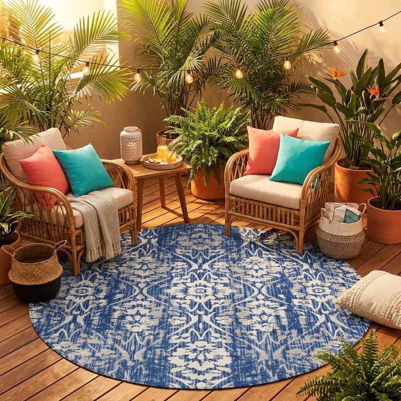 Round blue area rug with white damask pattern, laid flat on hardwood