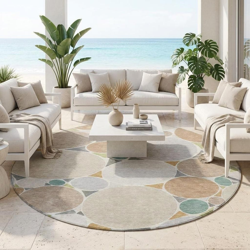 Round geometric area rug in beige, gray, and teal on indoor flooring
