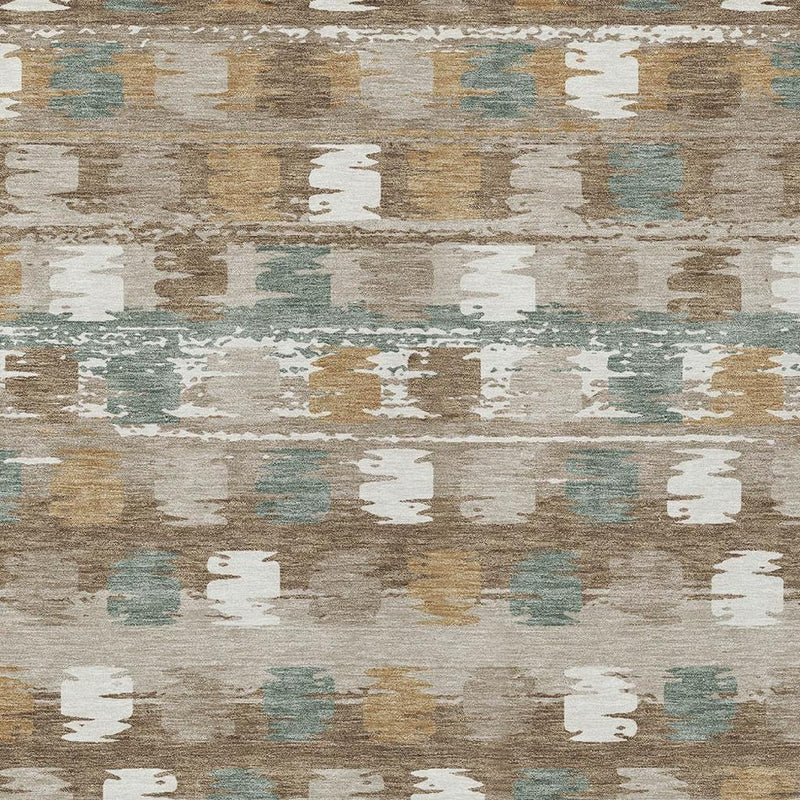 Close-up of brown, aqua, and ivory abstract distressed area rug with stacked blot shapes