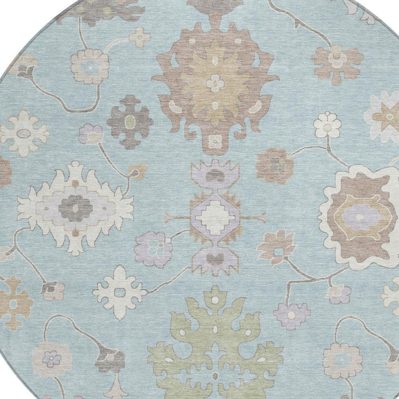 Blue round area rug with repeating snowflake-like floral motifs and vine lines