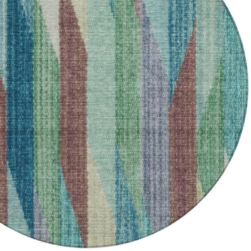 Partial view of round rug with vertical stripes in teal, turquoise, green, and brown