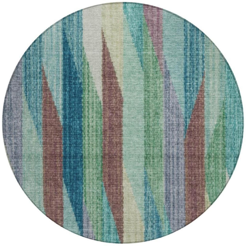 Round area rug with vertical striped pattern in teal, turquoise, green, and brown