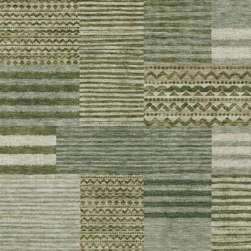 Close-up of green and sage area rug showing striped weave and patterned inserts