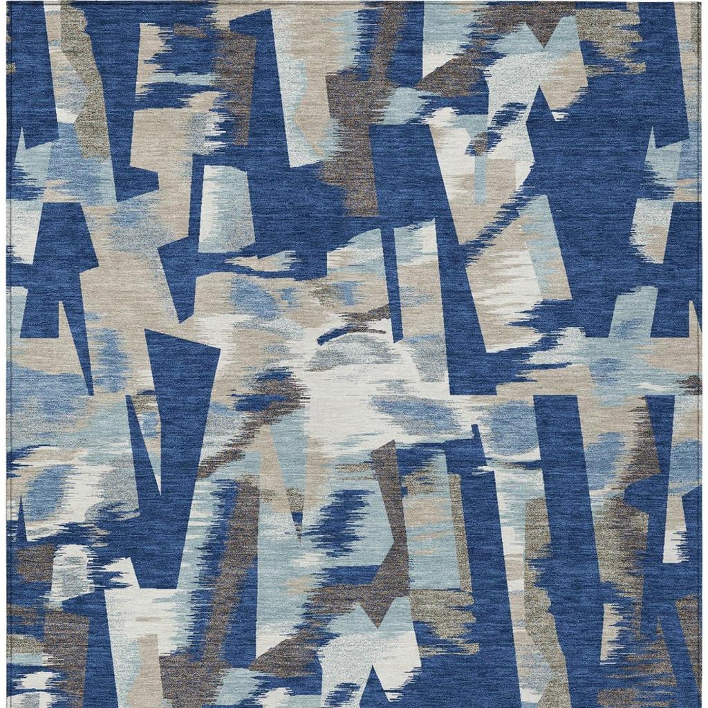 Abstract area rug surface with blue, beige, and tan block motifs