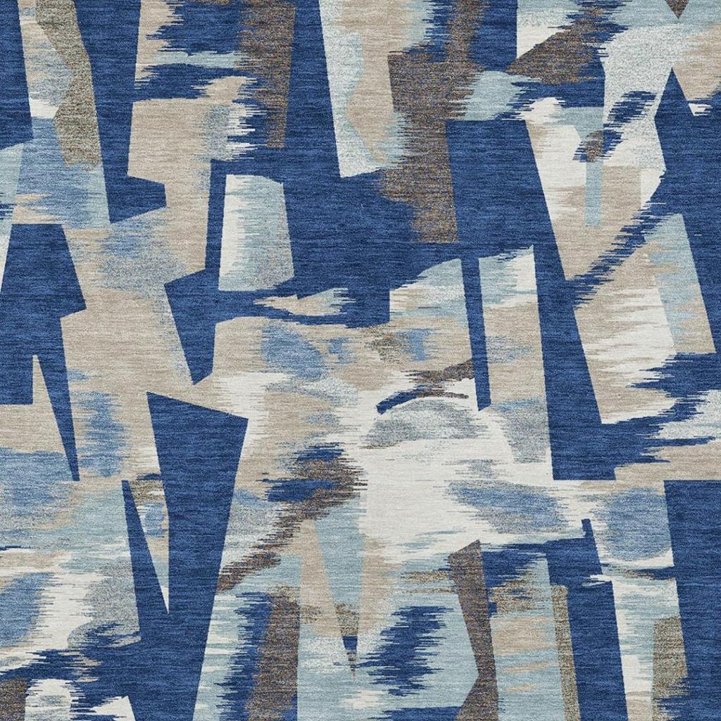 Abstract area rug with blue and beige angular shapes and distressed texture