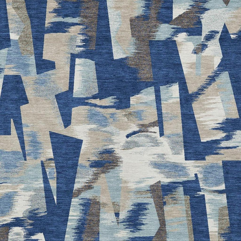 Abstract area rug with blue and beige angular shapes and distressed texture