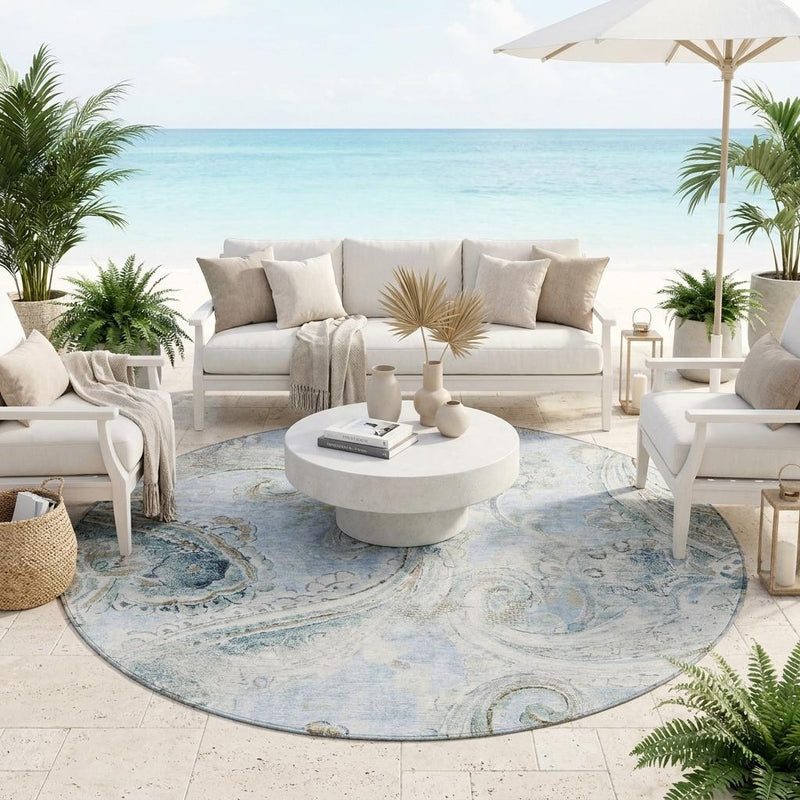 Round area rug featuring sky blue and blue paisley swirls, full circular view