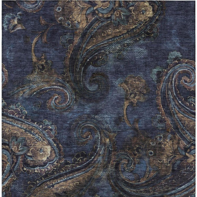 Navy blue paisley rug with detailed swirls and ornate border motifs in blue and tan