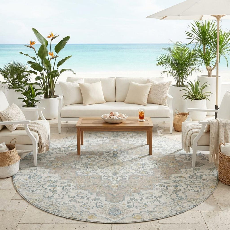 Round area rug in a living room setting, featuring blue, ivory, and taupe medallions