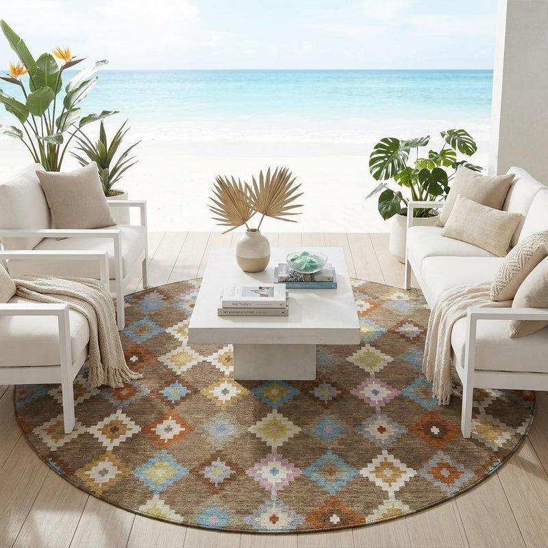Round area rug with brown base and multicolor geometric pattern in a living room setting
