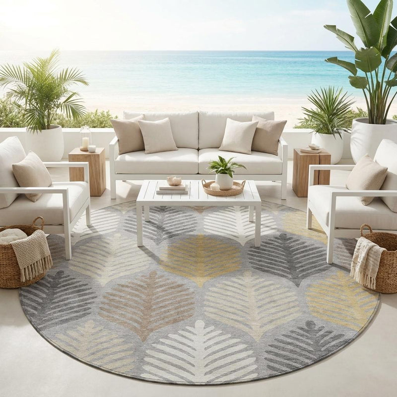 Round gray area rug with beige and light yellow leaf pattern in an outdoor patio seating area.