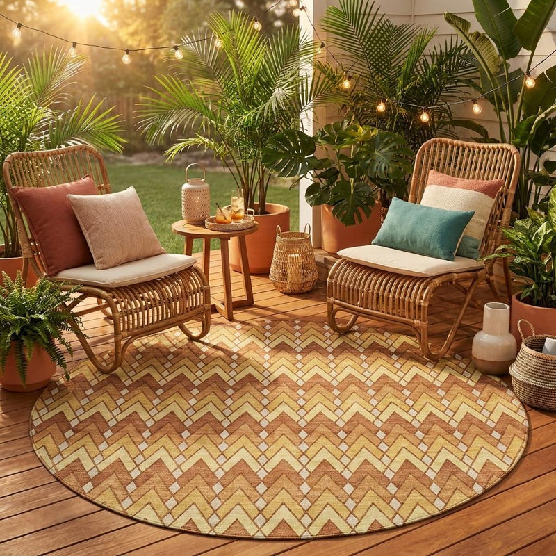 Round indoor outdoor area rug with zigzag geometric pattern in orange, copper, and tan