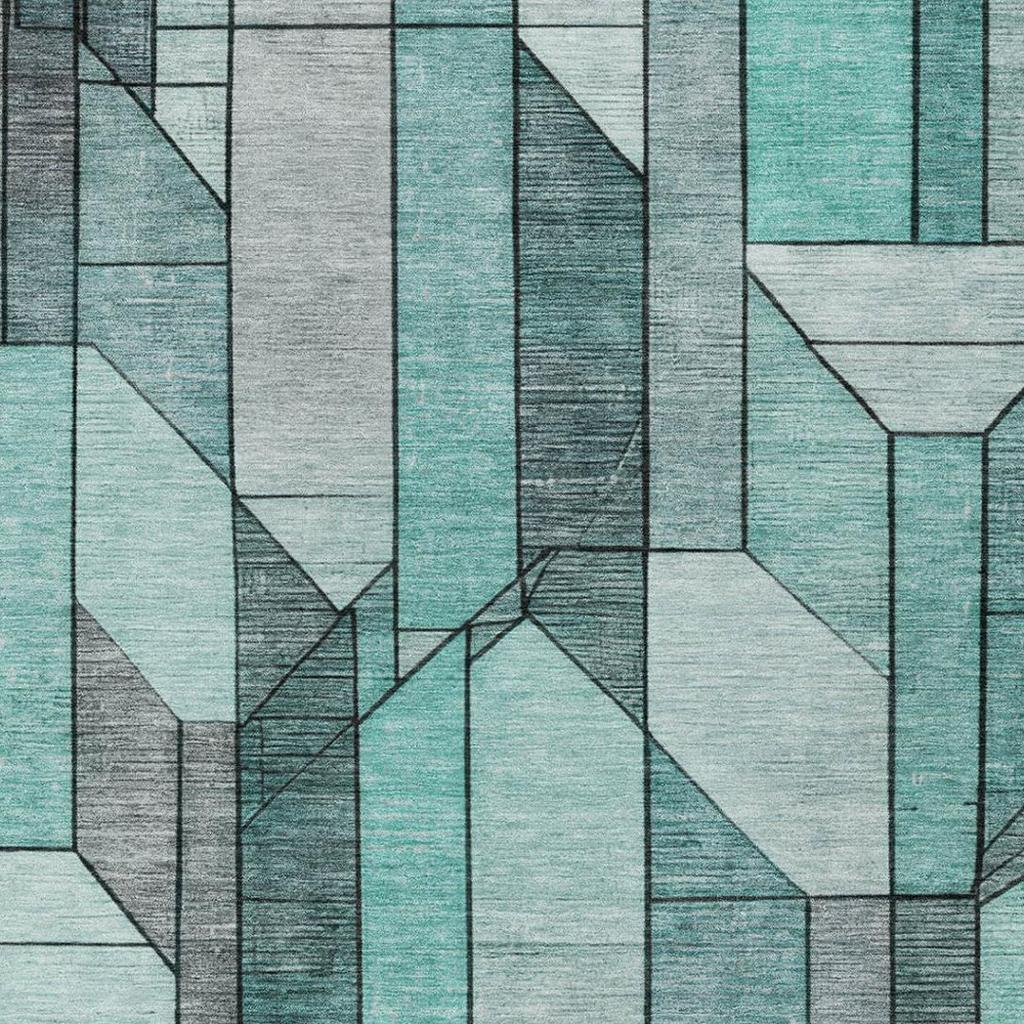 Geometric area rug with layered teal and gray cube-like shapes on a light background