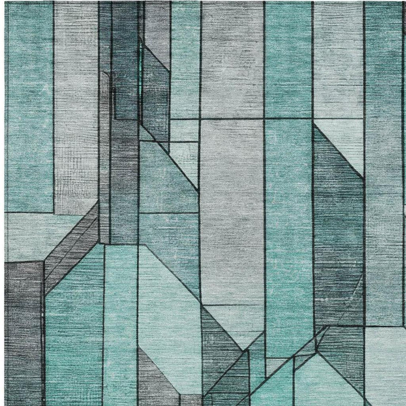 Square area rug with raised-looking block geometry in aqua teal, gray, and white