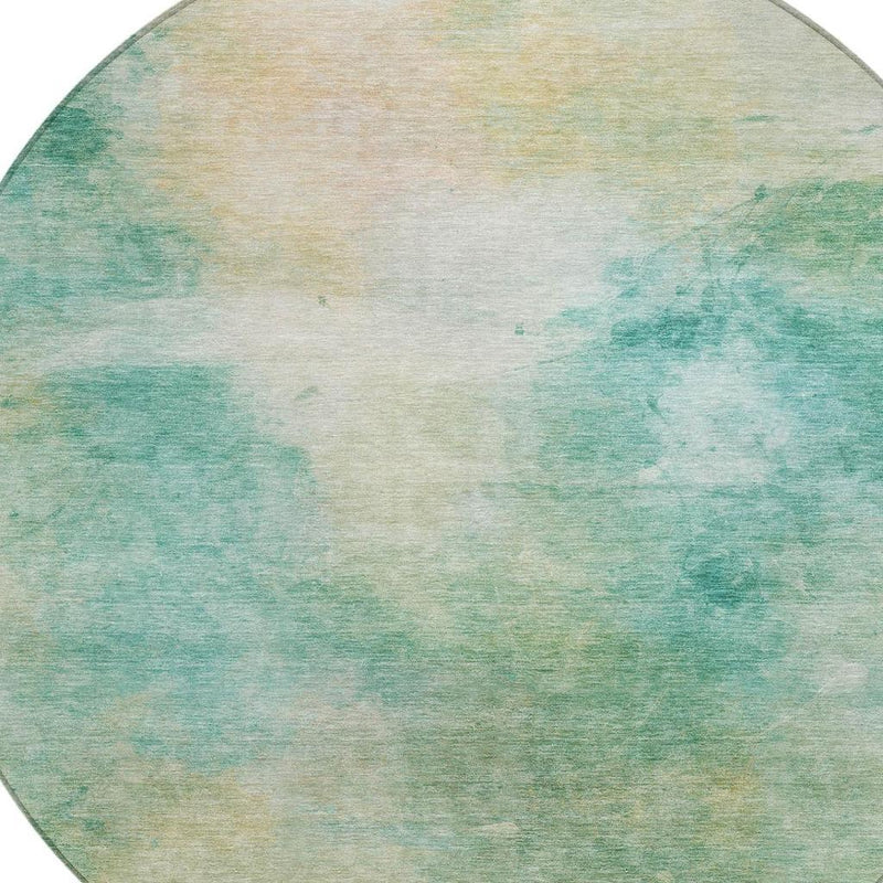 Round abstract area rug with aqua-teal speckled wash and light center