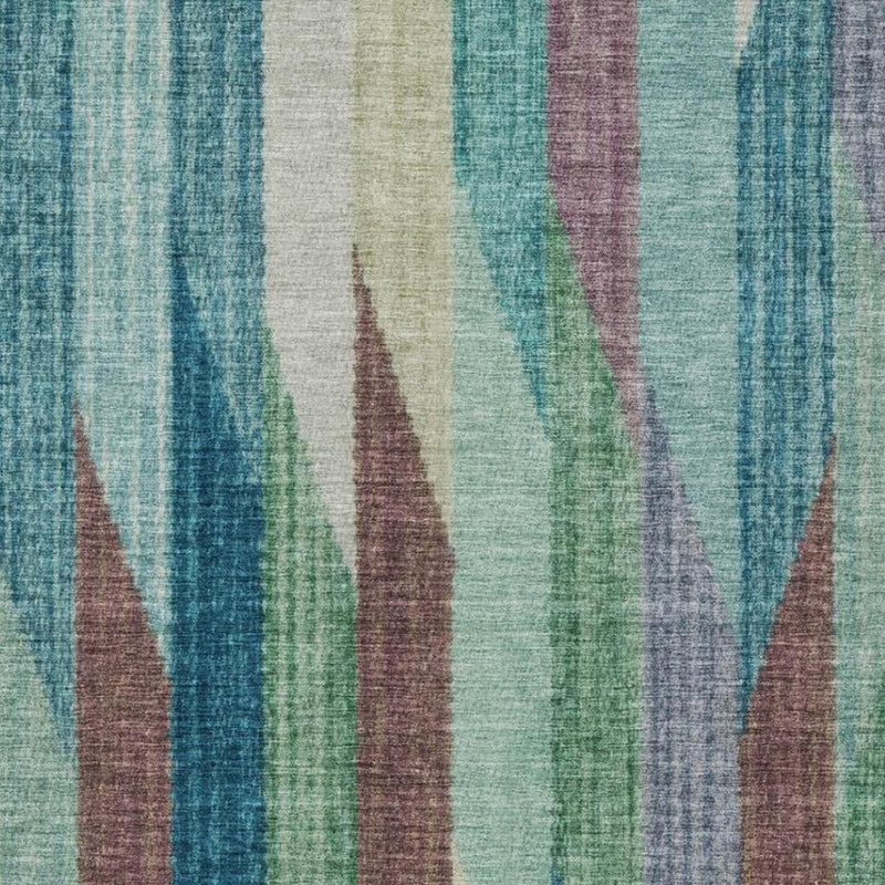 Close-up striped area rug texture with teal, turquoise, and multicolor vertical wave pattern