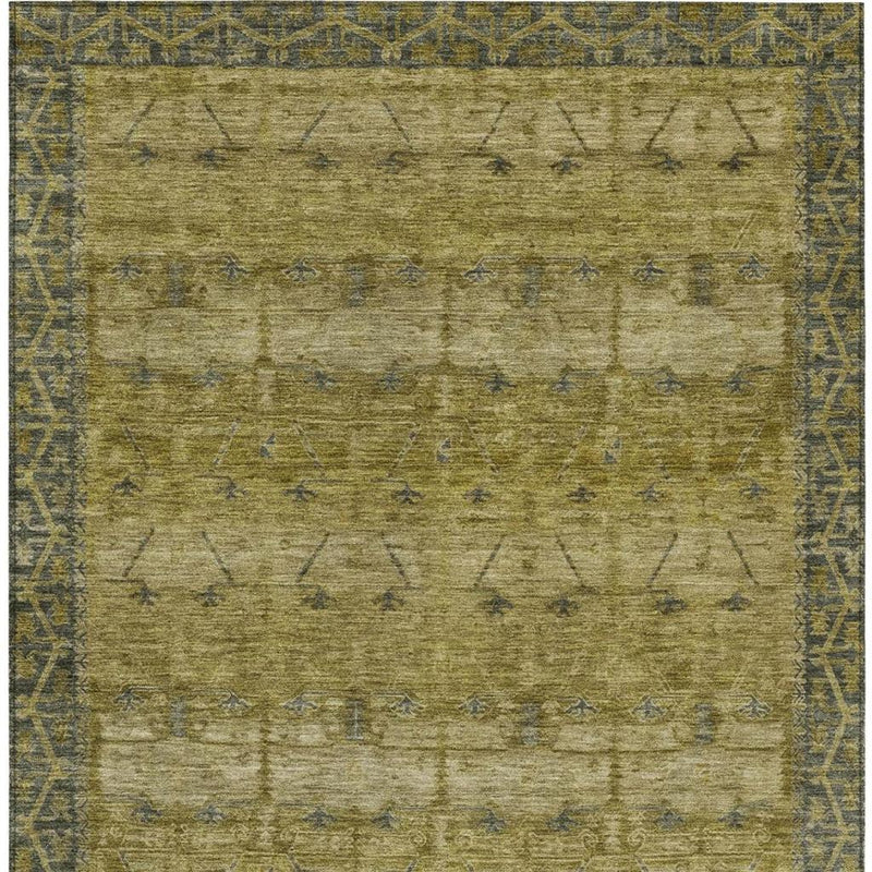 Close view of olive tribal area rug with blue geometric motifs and patterned border edges.