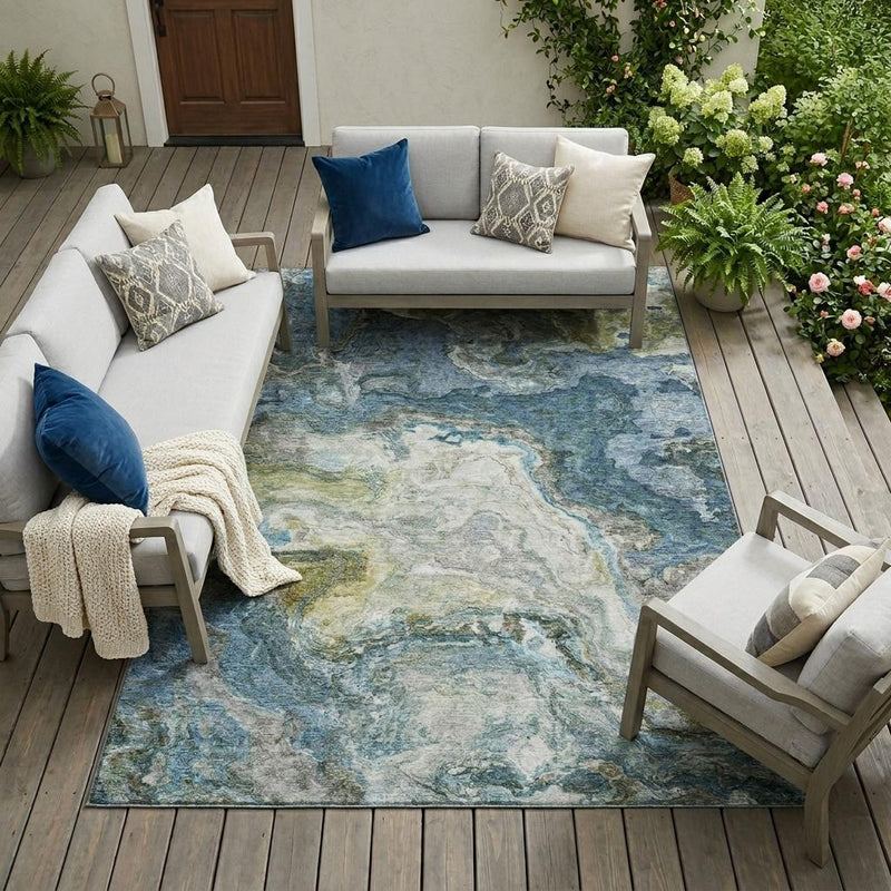 Blue abstract indoor outdoor area rug with watercolor-like distressed texture and border