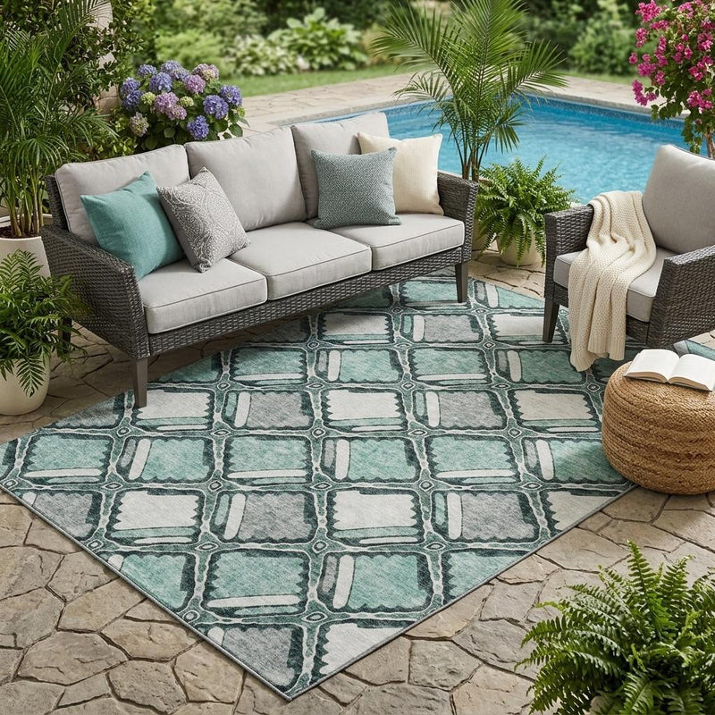 Aqua and teal geometric diamond patterned indoor outdoor area rug with washable flat pile